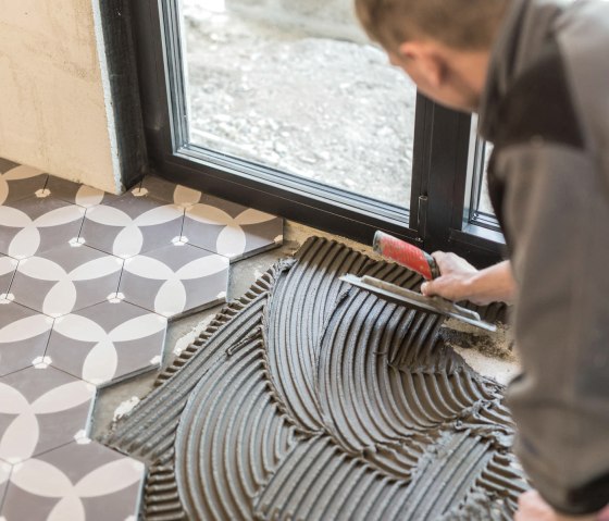 Mit Liebe zum Detail - wie hier beim Fliesenlegen Mit Liebe zum Detail - wie hier beim Fliesenlegen